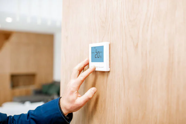 Hand setting temperature on a smart wall thermostat
